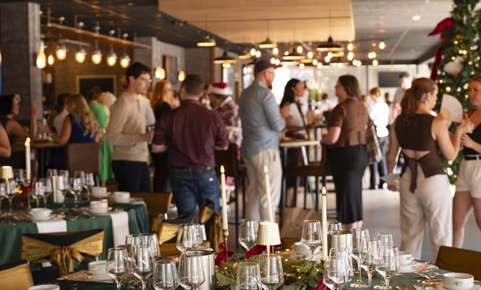 Guests enjoying welcome drinks and networking at a corporate event at Principality Stadium in Cardiff.